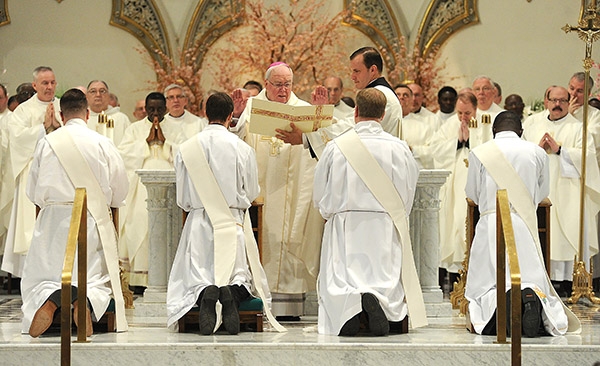 Area clergy bless newly ordained priests Father Luke Uebler, Father Cole Webster, Father Robert Agbo and Father Martin Gallagher on the altar during the Ordination Mass at St. Joseph Cathedral. (Dan Cappellazzo/Staff Photographer)